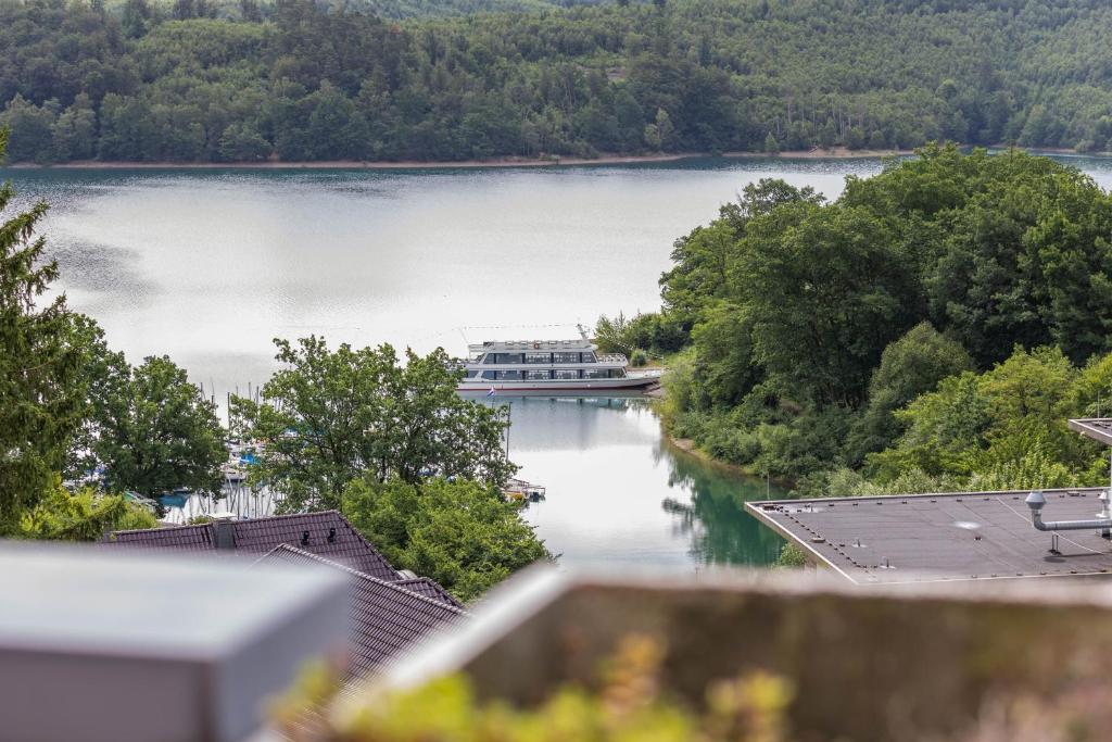 a boat is docked on a large lake at Traumwohnung am Sorpesee in Sundern