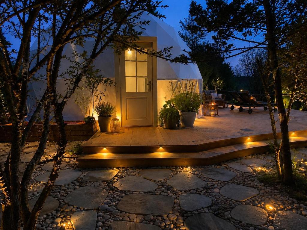 a house with a porch at night with lights at Saare Glamping Dome House in Salme