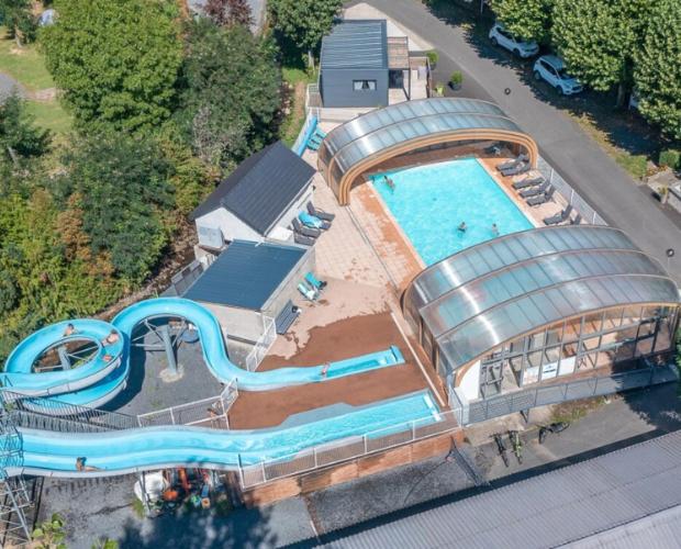 an overhead view of a water park with a pool at La Villa du Pont Romain in Saint-Nectaire