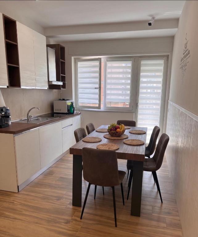 a kitchen with a table and chairs in a room at Anima Est in Naples