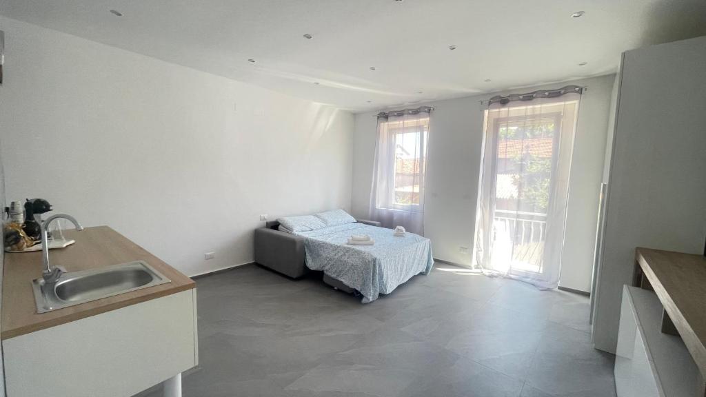a kitchen with a bed in the corner of a room at CENTRAL LUXURY Rooms in Grugliasco