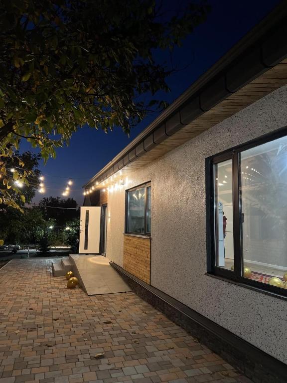 a house with lights on the side of it at Ala-Archa Mountain House in Vorontsovskoye