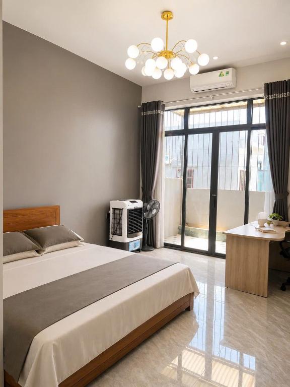 a bedroom with a bed and a tv in it at Homestay ĐAN MY 2 in Trung Nghĩa