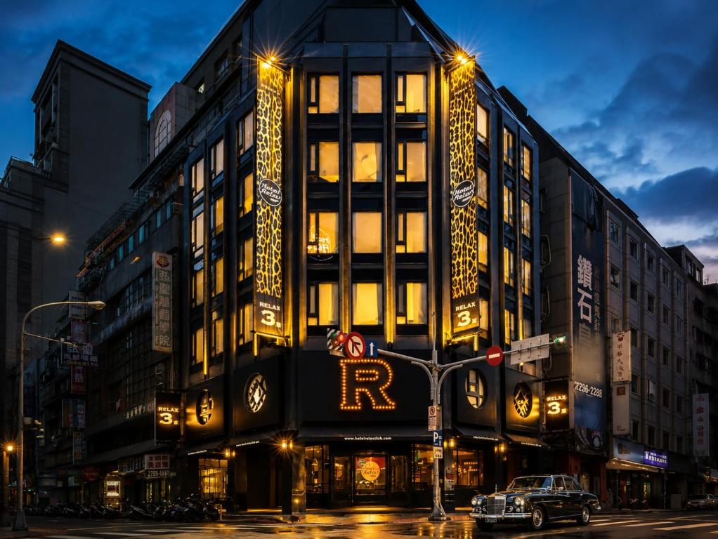 a building on a city street at night at Hotel Relax III in Taipei