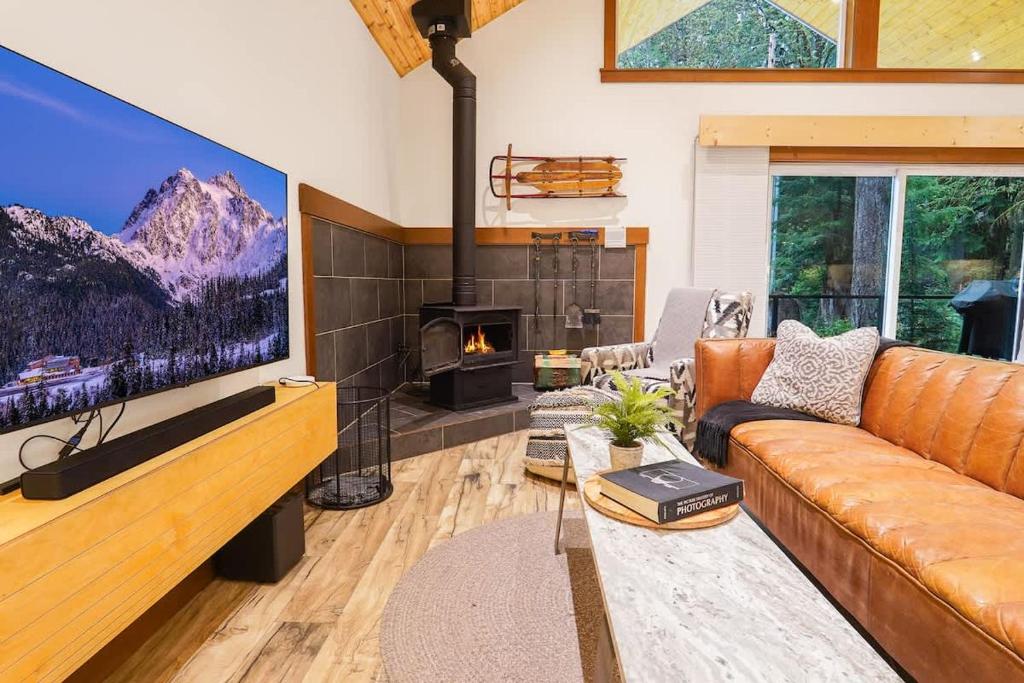 a living room with a couch and a large tv at Swiss Marmot in Glacier