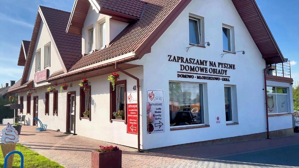 a building with a sign on the side of it at Serce in Sokółka