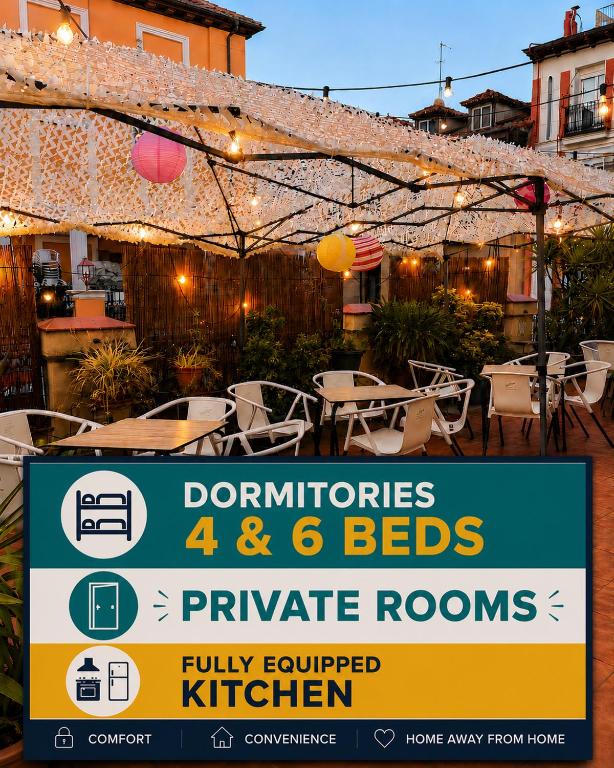 a sign in front of a patio with tables and chairs at Barbieri Sol Hostel in Madrid