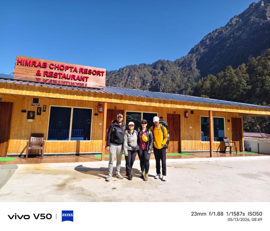 a group of people standing in front of a building at Himrab Chopta Resort in Chopta