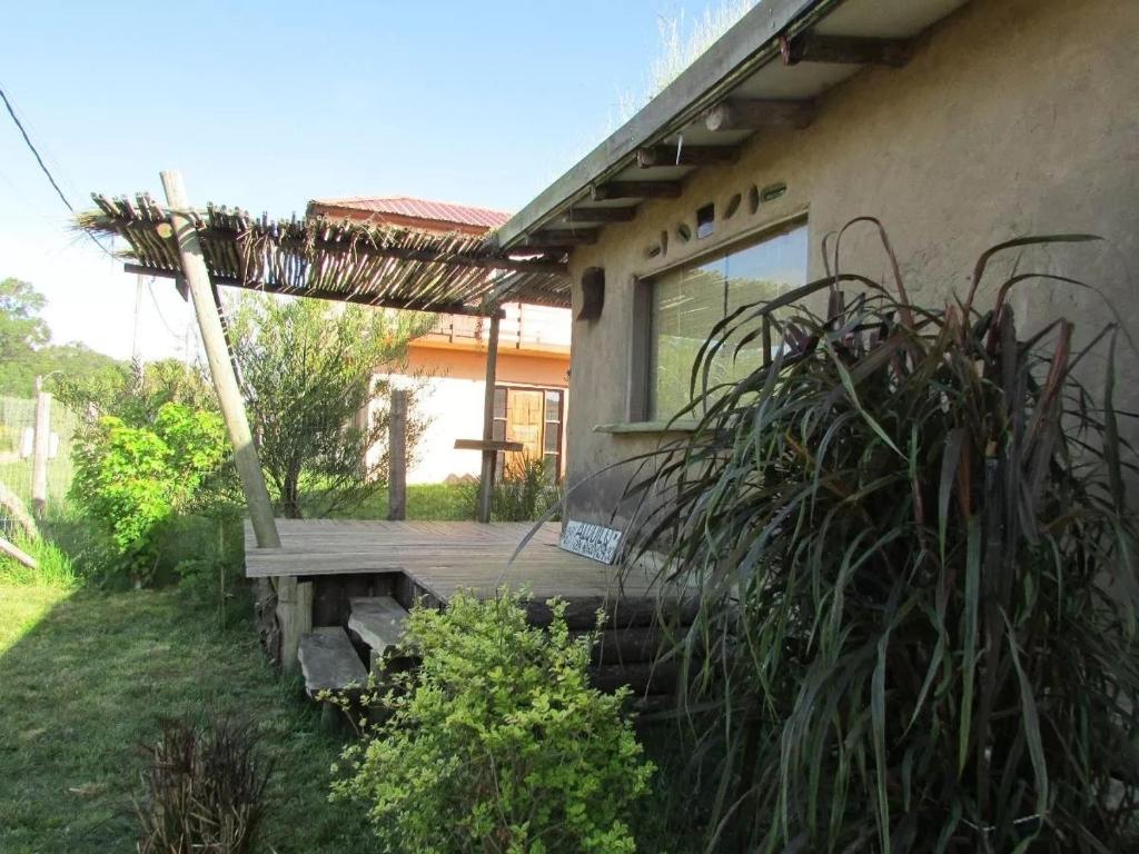 a porch of a house with a wooden deck at Casas de barro in La Pedrera