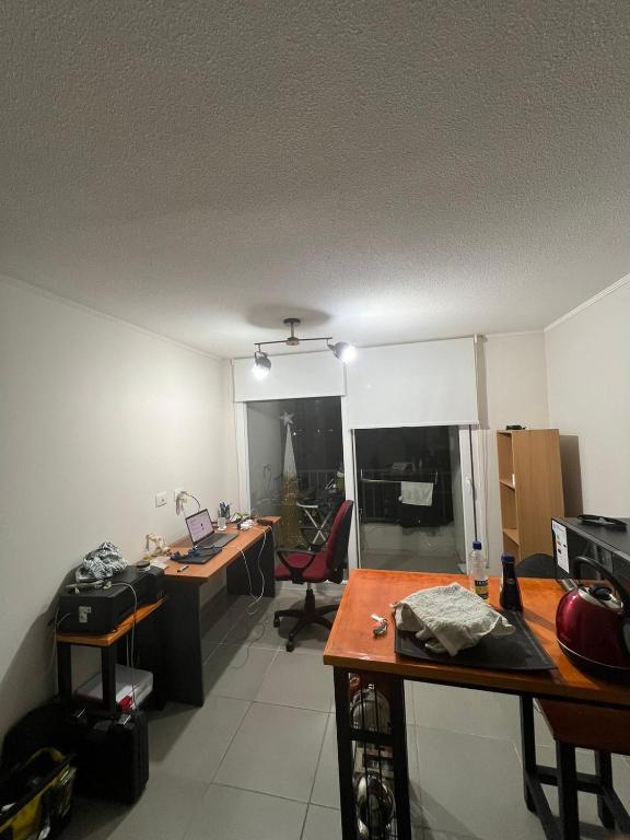 an office with a desk and a computer in a room at Urbano Talca in Talca