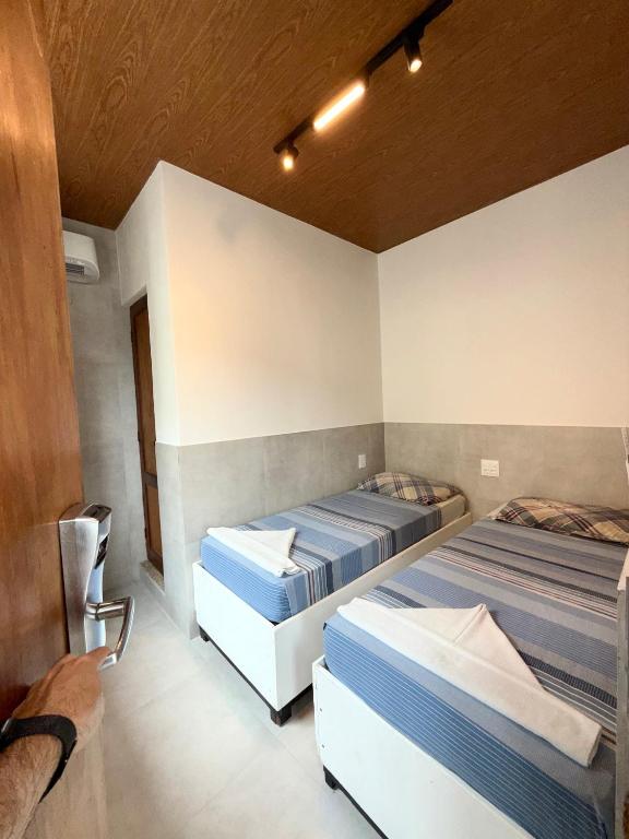 a bedroom with two beds in a room at Hotel Pousada da Praia in Recife