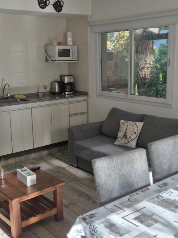 a living room with a couch and a table at Casa Cris Pinamar in Pinamar