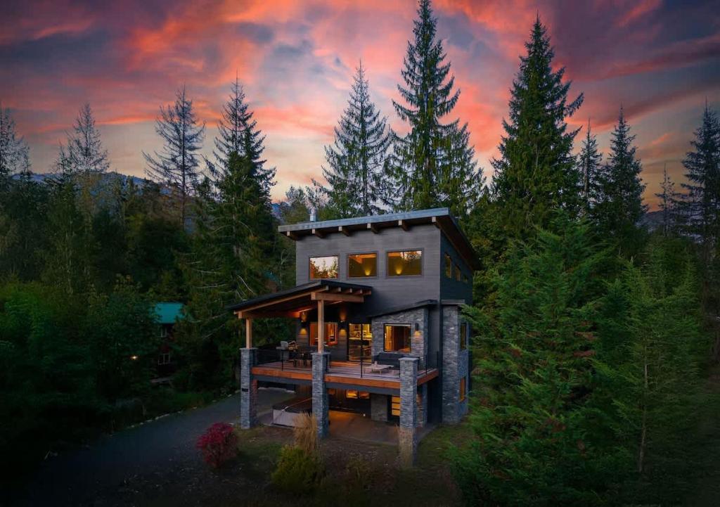 a small house in the middle of a forest at Whistler Peak Lodge in Glacier