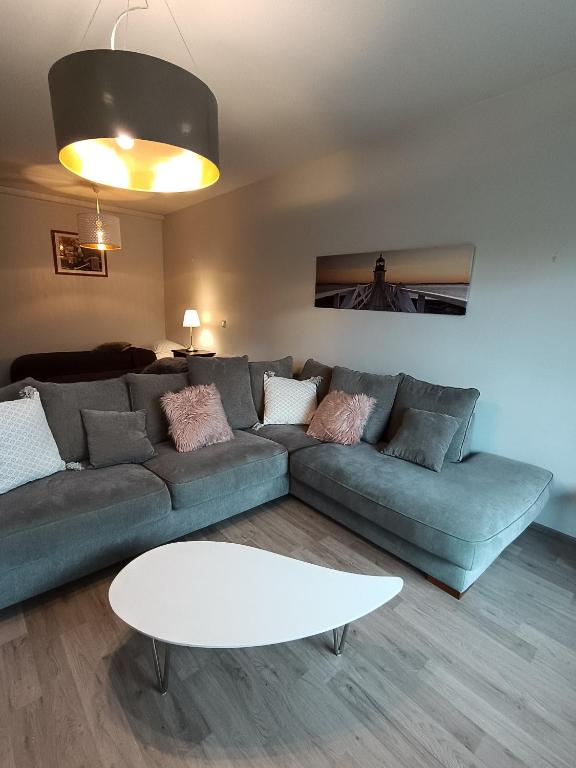 a living room with a couch and a table at Walhalla Kuhala apartment in Forssa