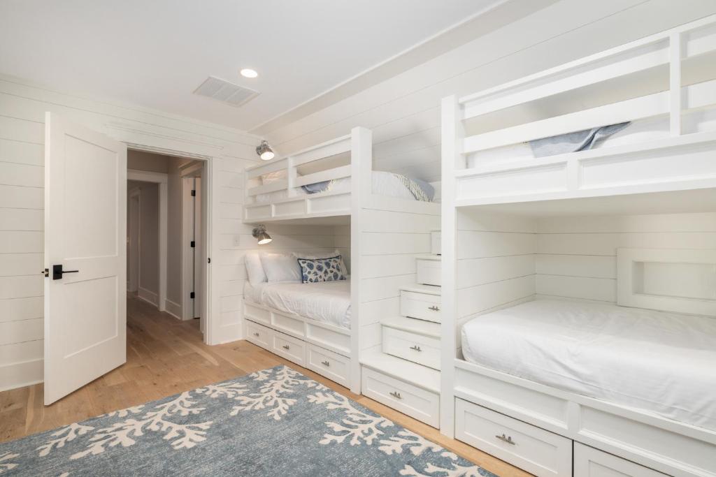 a bedroom with two bunk beds and a rug at 26th Ave 23 in Isle of Palms