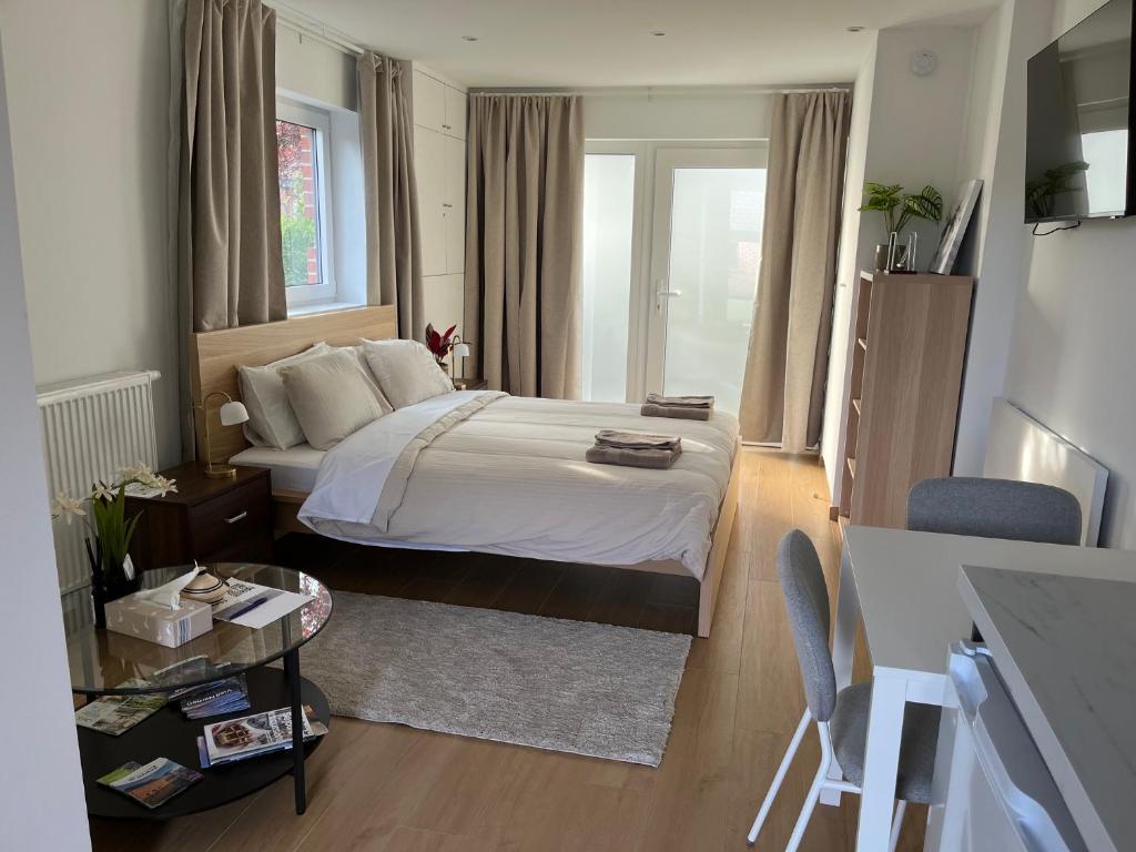 a bedroom with a large bed and a window at Aux Boutons d'Or in Namur