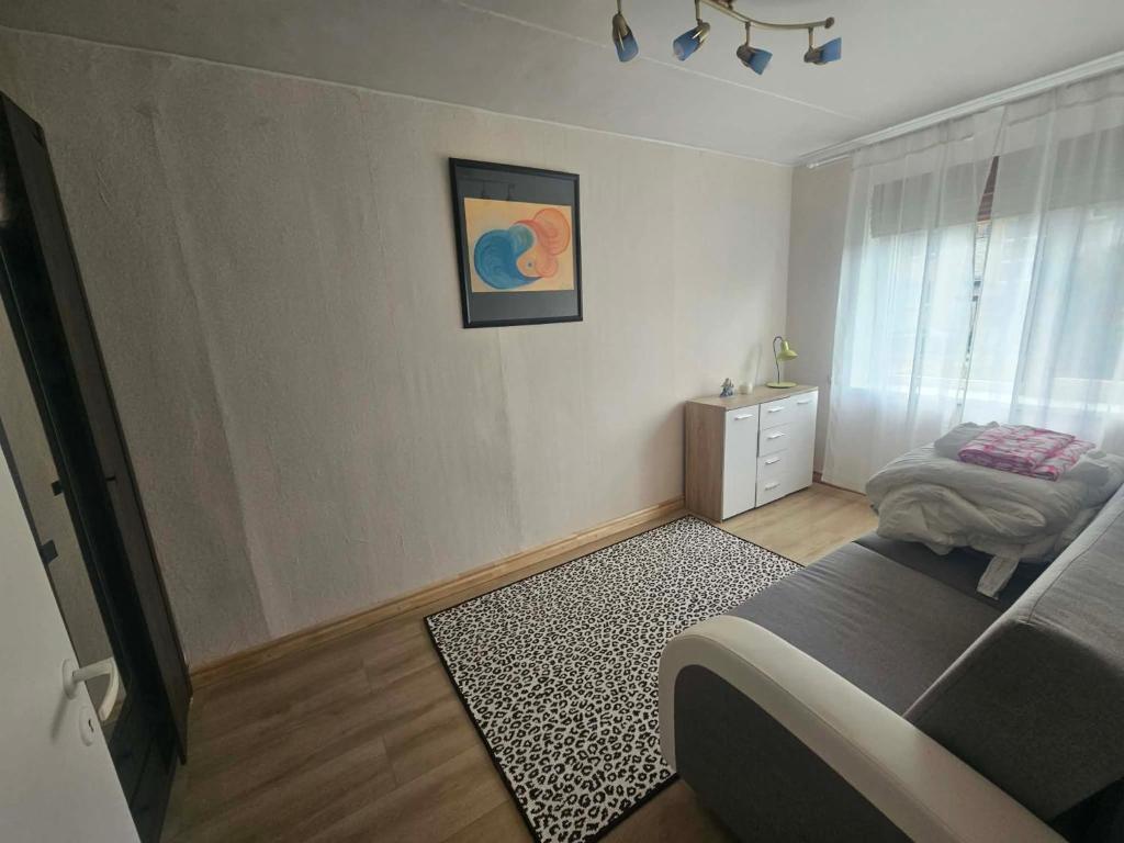a bedroom with a bed and a dresser and a window at Laeva in Pärnu