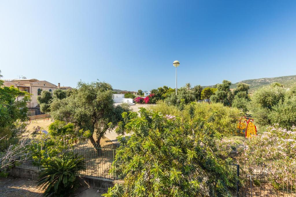 a view of a garden with trees and flowers at Via Tirso Rooms & Studio in Tortolì
