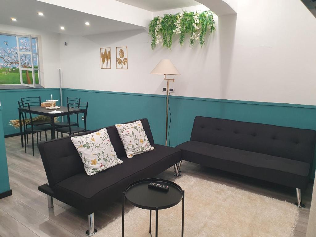 a living room with a couch and a table at La Casetta in Genoa