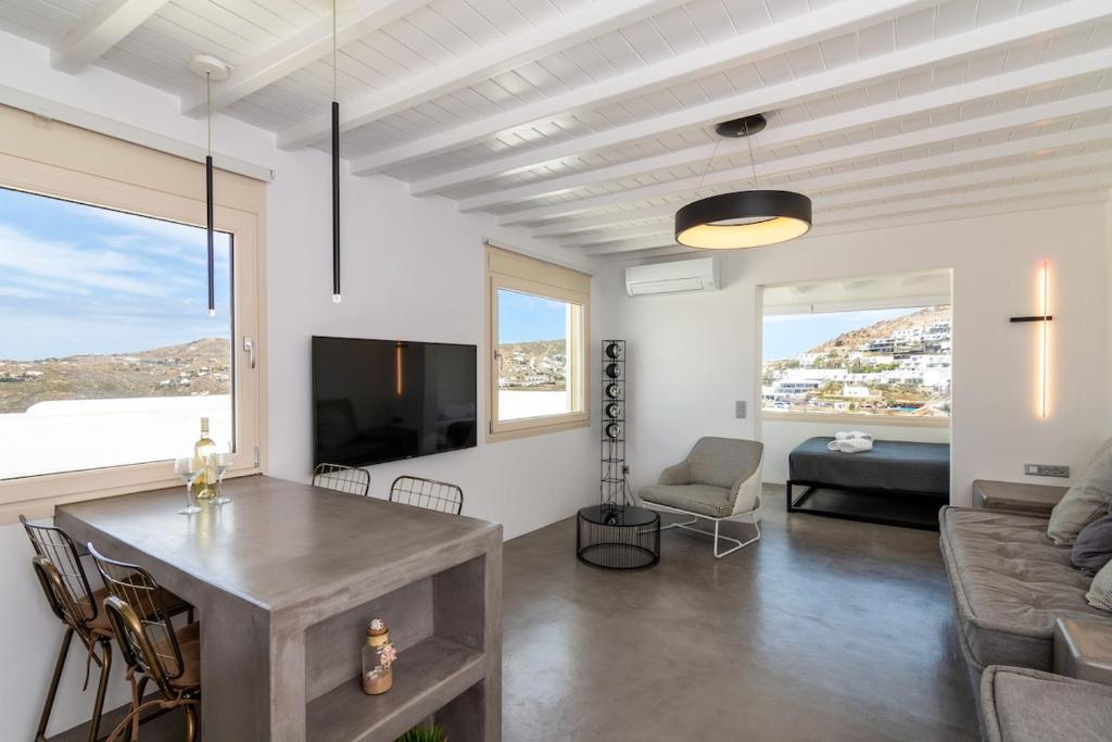 a living room with a table and a couch at The Rock View Apartment in Mikonos