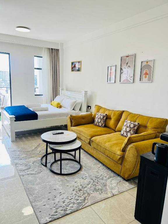 a living room with a couch and a table at Nyvin Homes at The Loftel in Ruaka