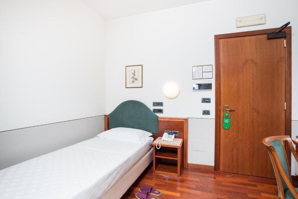 Postel nebo postele na pokoji v ubytování Terra Umbra Hotel