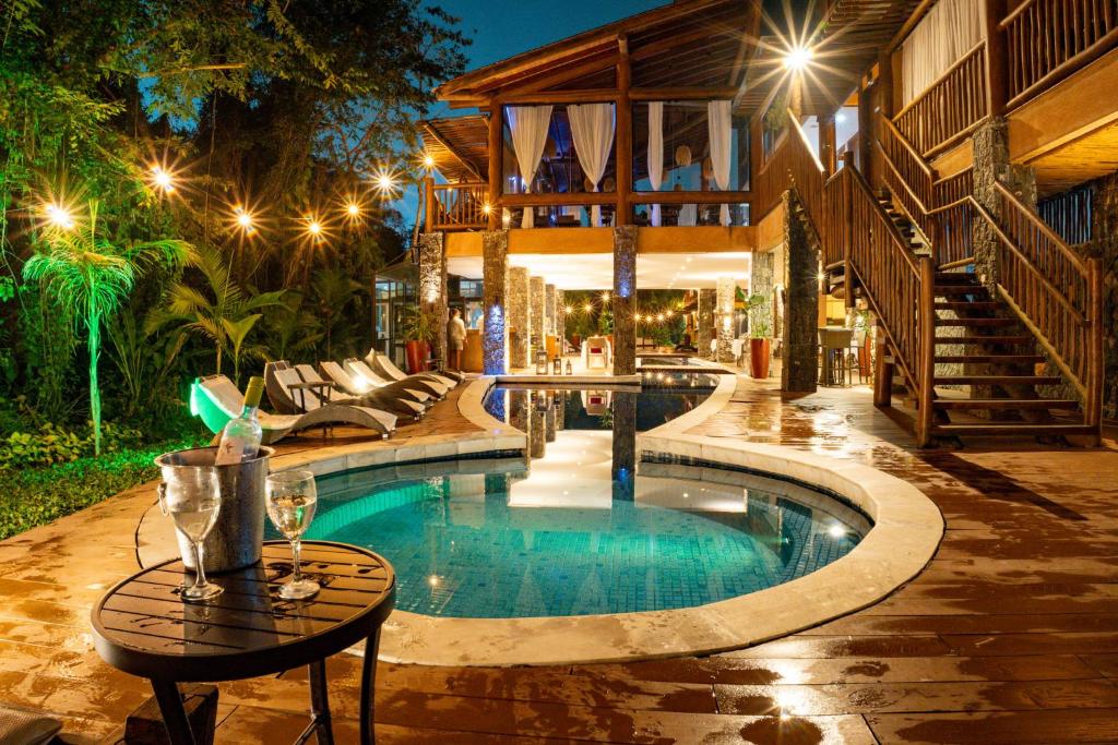 a swimming pool in the middle of a yard at night at Kalango Hotel Boutique in Ilhabela