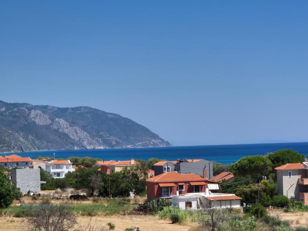 a group of houses on a hill next to the water at Seaside Vatera in Vatera
