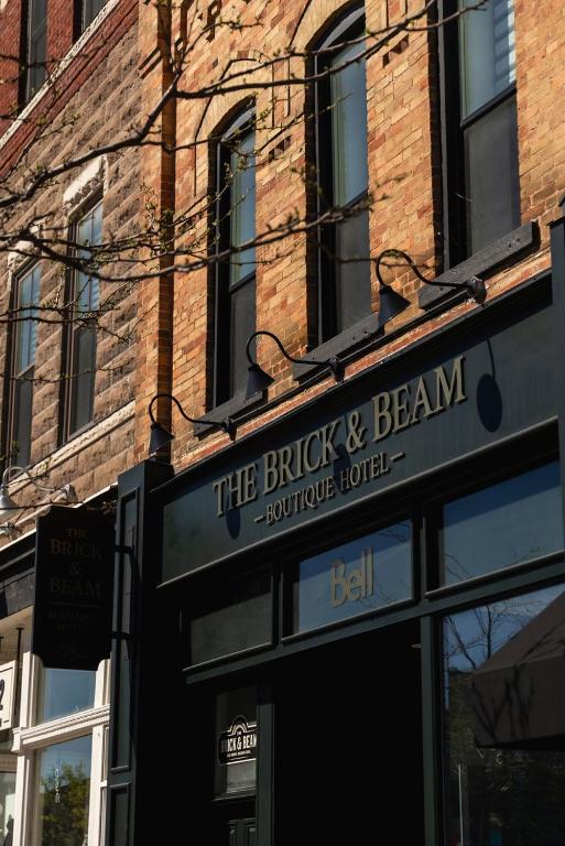 a sign in front of a brick building at The Brick & Beam Boutique Hotel in Collingwood