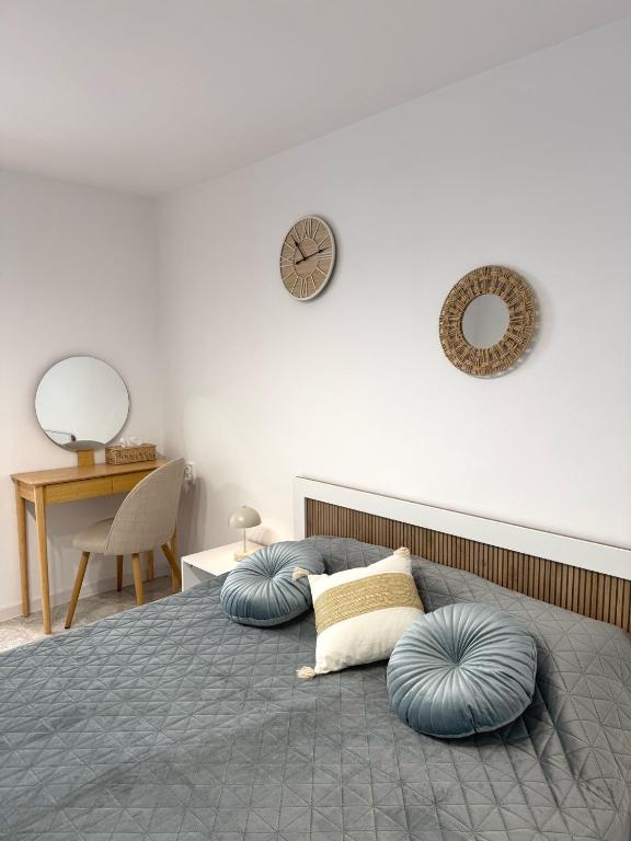 a bedroom with a bed with blue pillows on it at Nicola`s Apartment in Sozopol