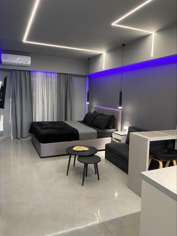 a bedroom with a bed and a couch and a table at Crystal Grey Elite Apartment 2 in Serres