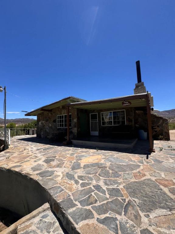 a stone patio in front of a building at Casa Andres in Camalú