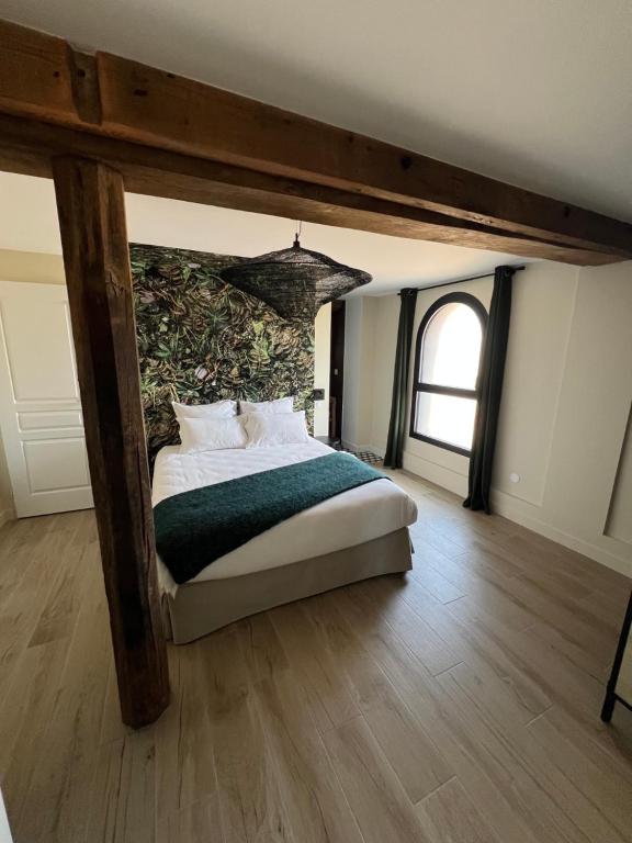 a bedroom with a bed with a stone wall at Suite Véloscénie in Lèves
