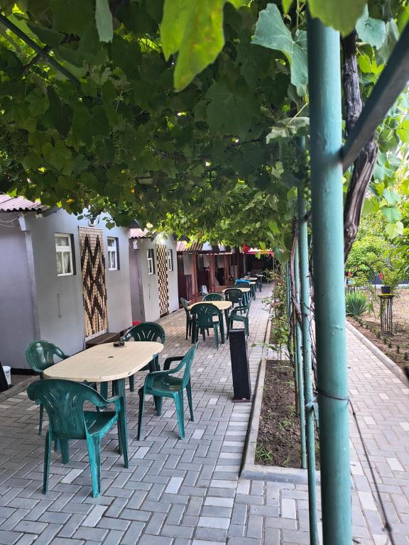 a row of tables and chairs on a patio at Casa Mihai in Costinesti