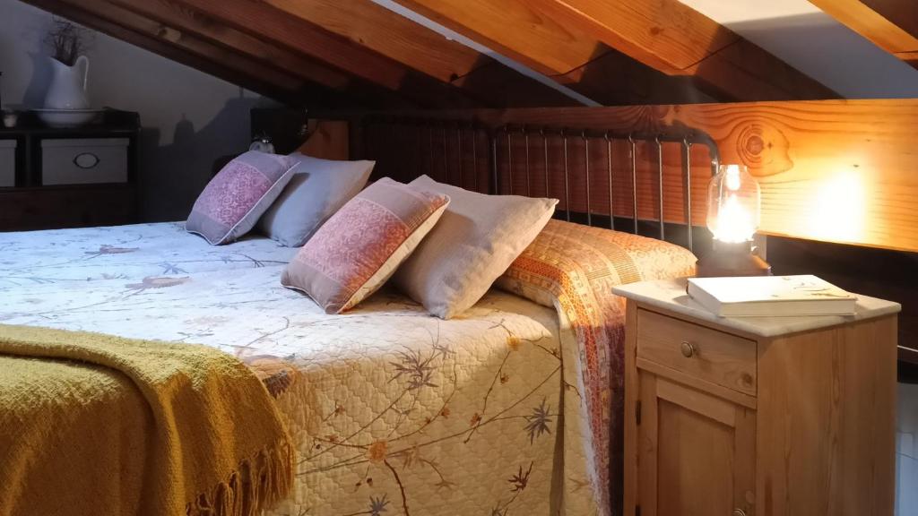 a bedroom with a bed with pillows on it at Casa Coba in Camijanes