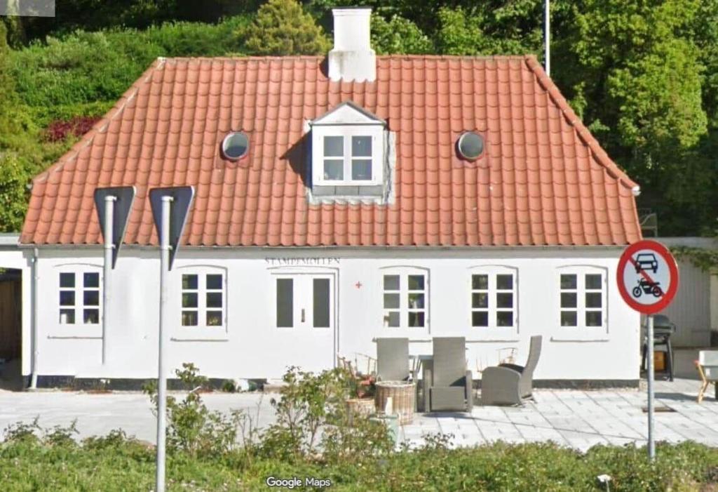 a white house with an orange roof at OH596-Mariager-Ostergade-38 in Mariager