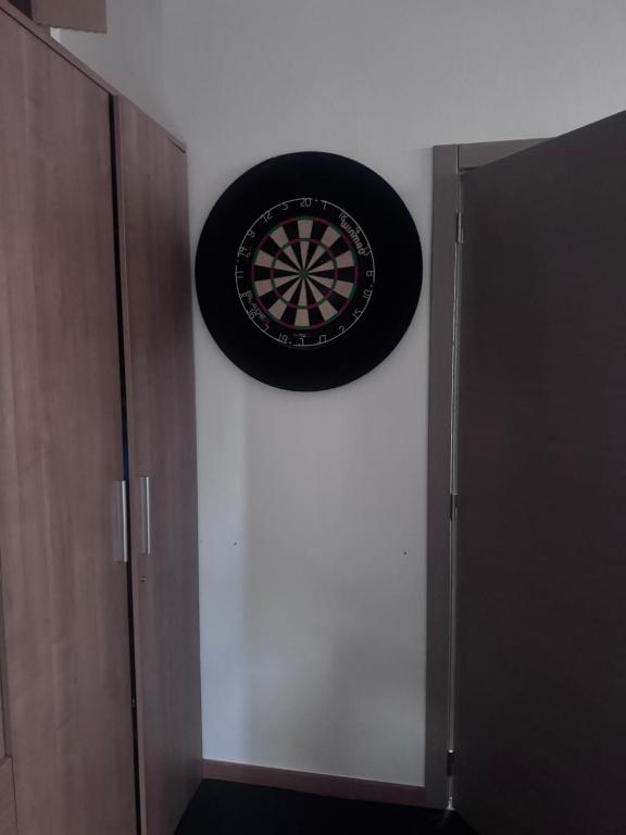 a dart board on a wall next to a door at Logies2460 in Kasterlee