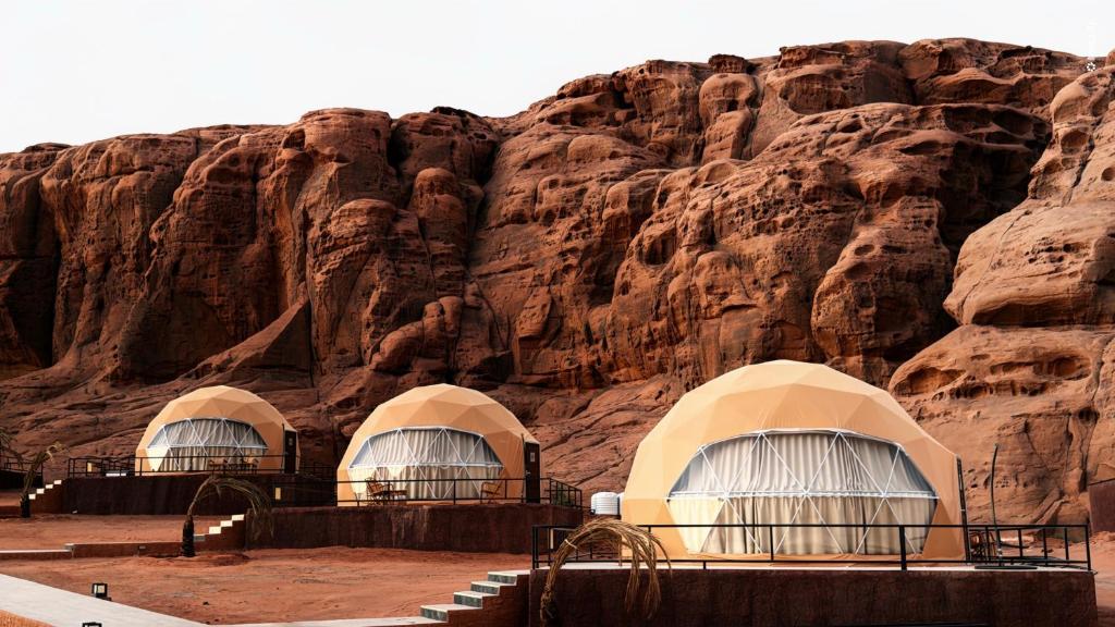 a group of domes in front of a mountain at Victoria Luxury camp in Wadi Rum