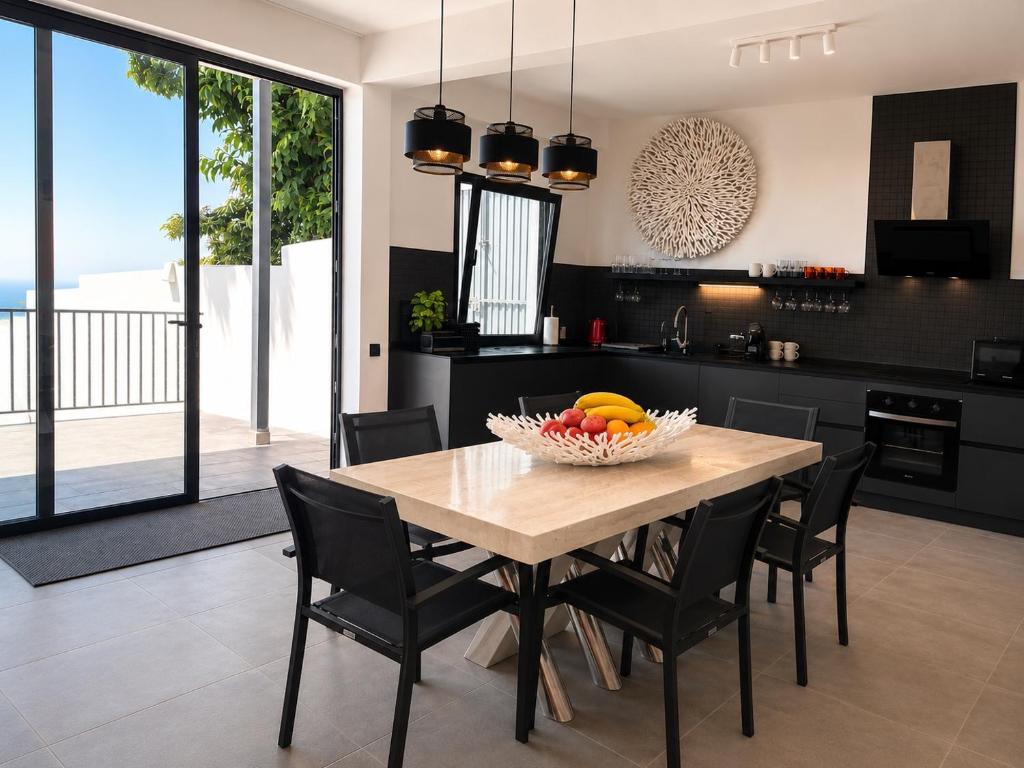a kitchen with a table with a bowl of fruit on it at Atlantic View Loft - Spa & Sunset in La Orotava