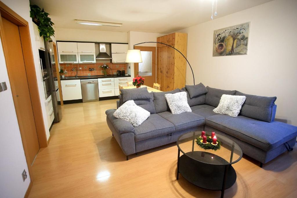 a living room with a couch and a table at Slunný byt v Berouně in Beroun