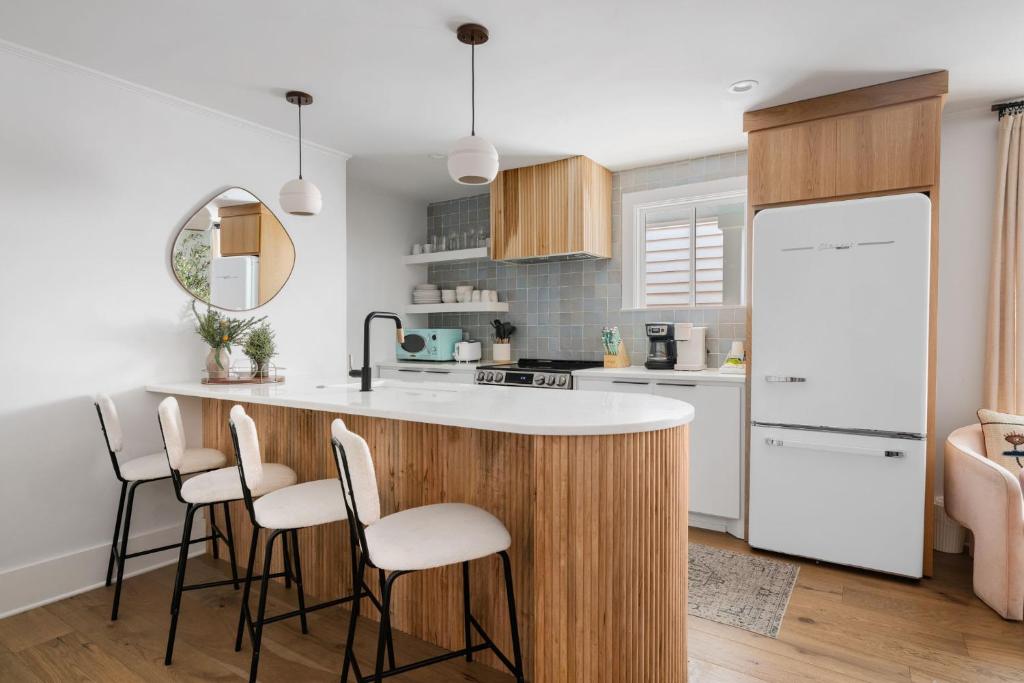 a kitchen with a large island with stools at Downtown CHS King Beds Convert to Singles in Charleston