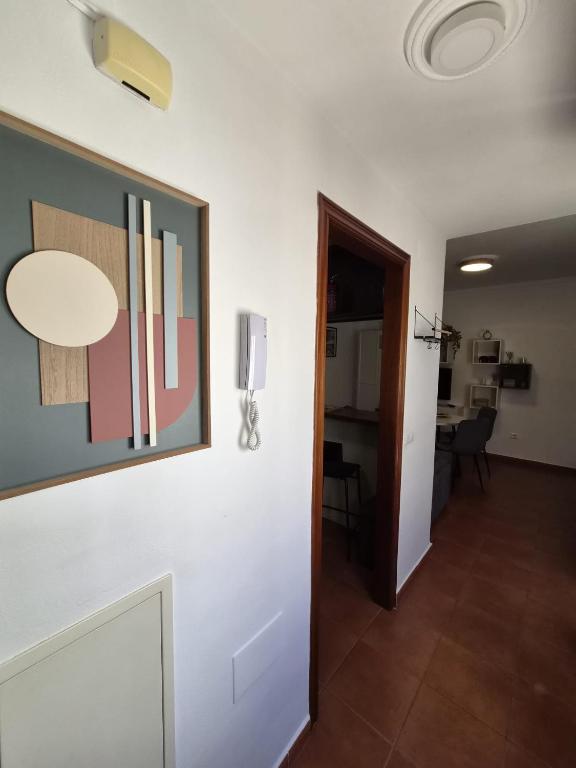 a hallway with a painting on the wall and a room at Apartamento click center in Ronda