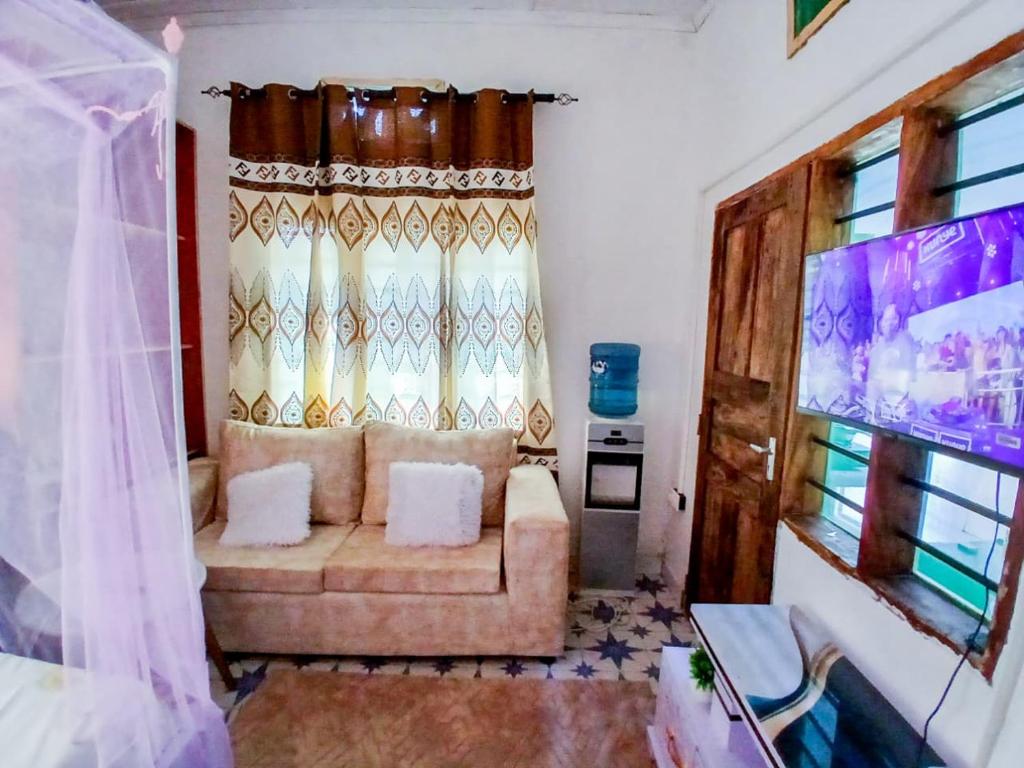 a living room with a couch and a window at Diamond luxury Studio Watamu in Watamu