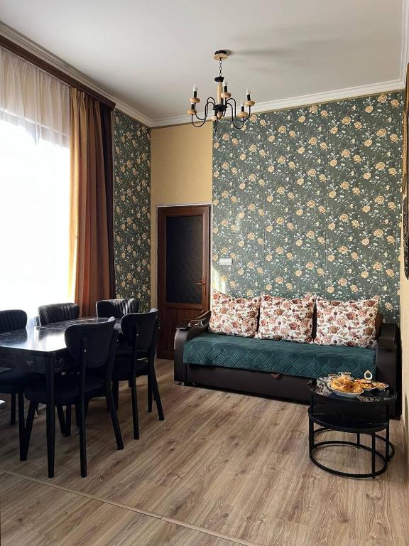 a living room with a green couch and a table at Noyemberyan Central Apartment in Noyemberyan