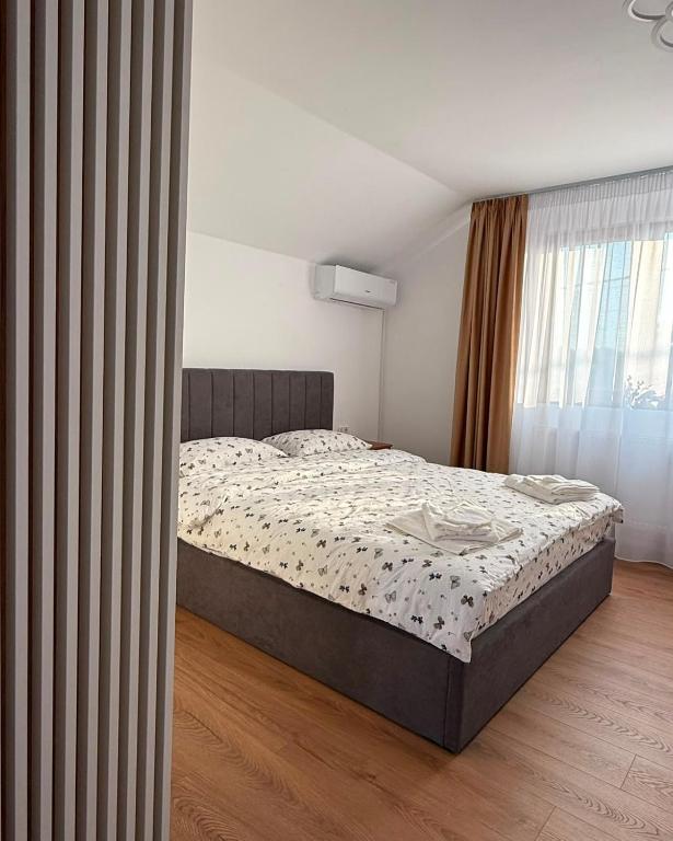 a bedroom with a large bed in a room at Luca Rooms in Curtea de Argeş