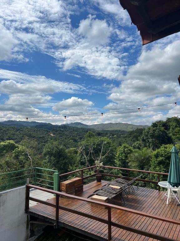 a deck with a view of the mountains at Villa Macacos in Nova Lima