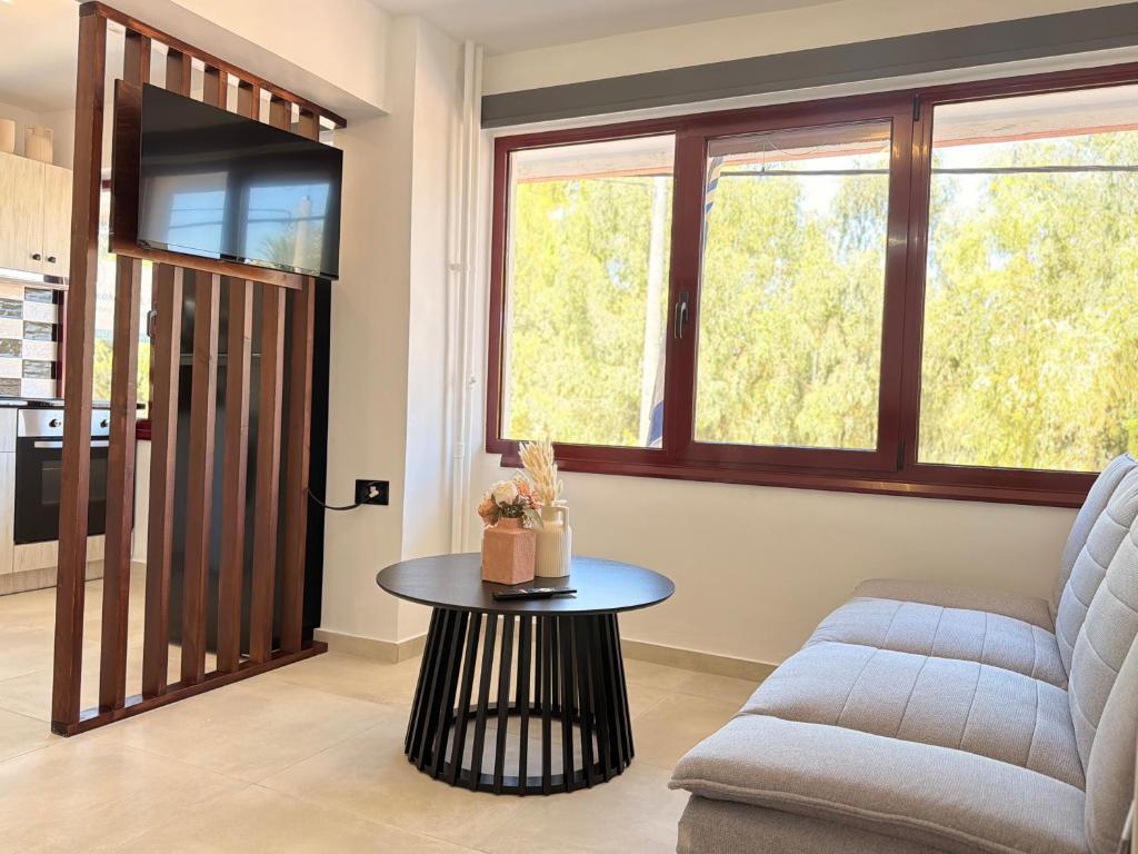 a living room with a couch and a table at Electra Chios apartment in Chios