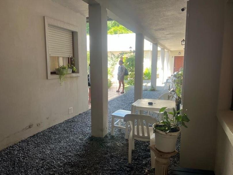 a room with a table and a person walking down a street at Espacio493 in Villa Gesell