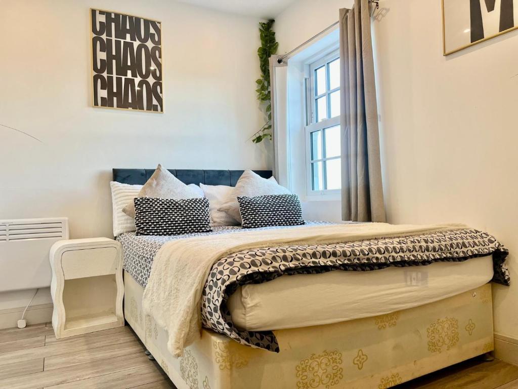 a bedroom with a large bed with a window at Sutton & Stone in Sutton