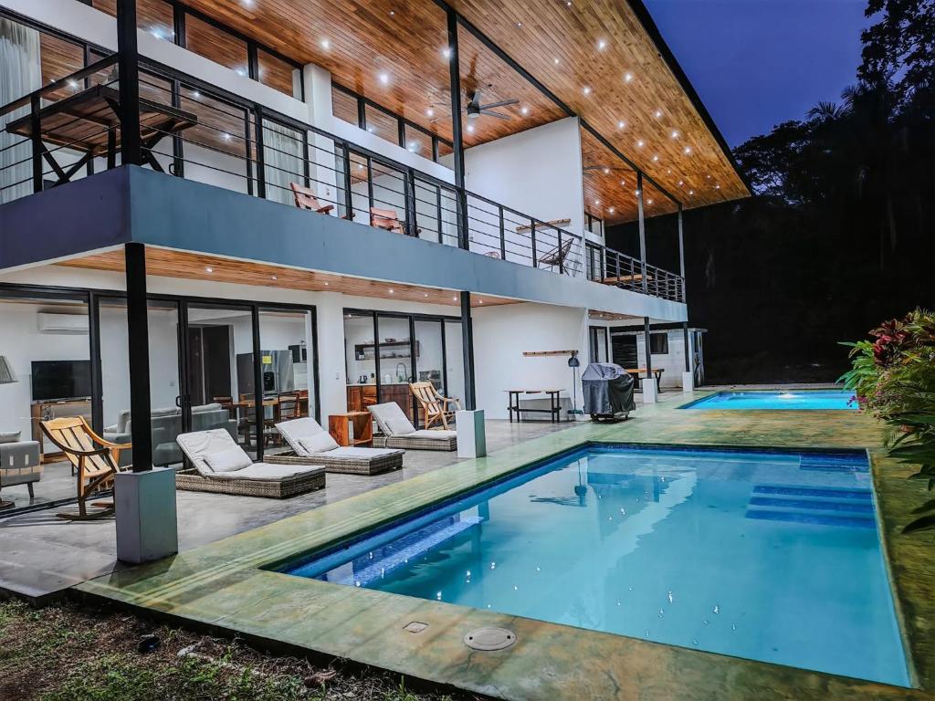 an exterior view of a house with a swimming pool at Samara by the River Vacation Suites in Sámara